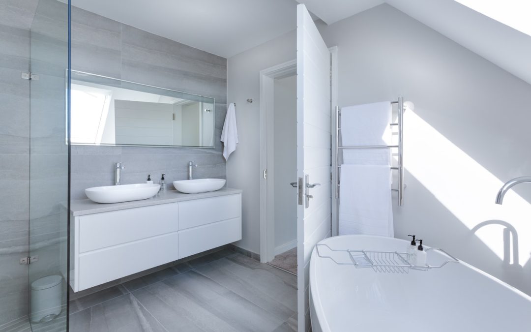 Wash room in white color with two vanities in white and a tub | airbnb and vocational rentals