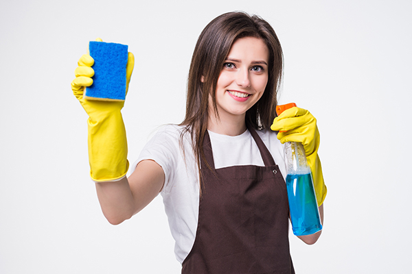 a cleaning maid holding a sponge and cleaning detergent